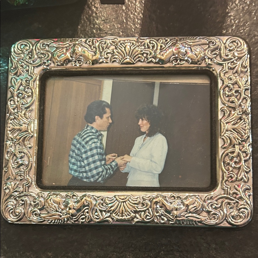 Sterling silver picture frame but it may just be plated. It shined up nicely.